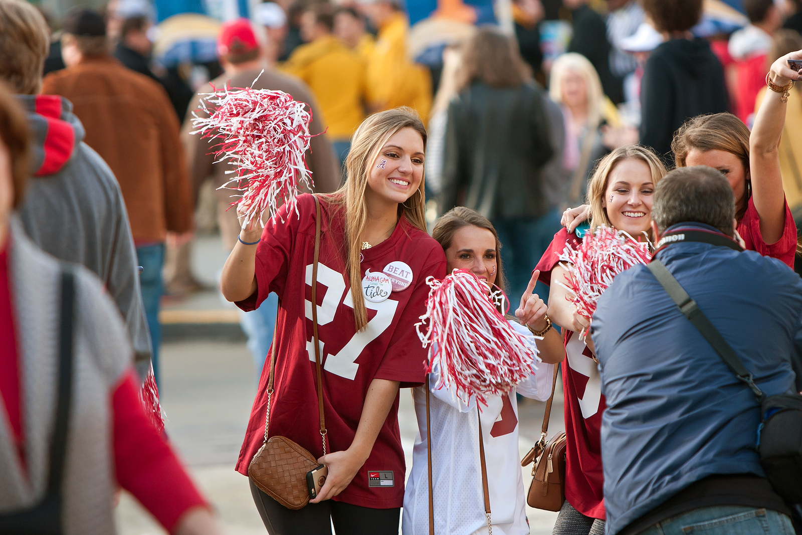 College football fans stand together to take a photo. They are feeling much happier after starting online therapy for college students in Alabama with Empower Counseling. 