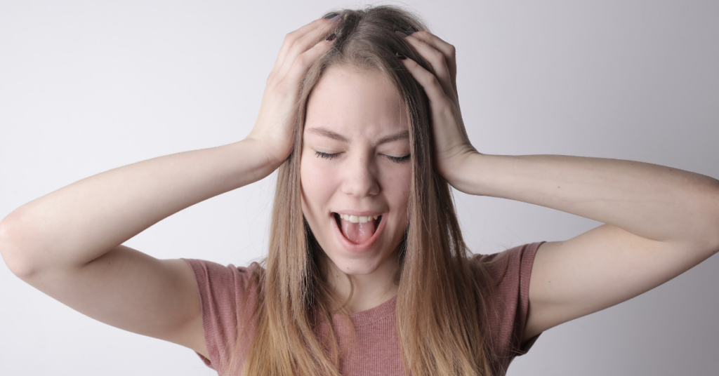 Upset girl with hands squeezing her head before anxiety counseling in Birmingham, Alabama with Empower Counseling 