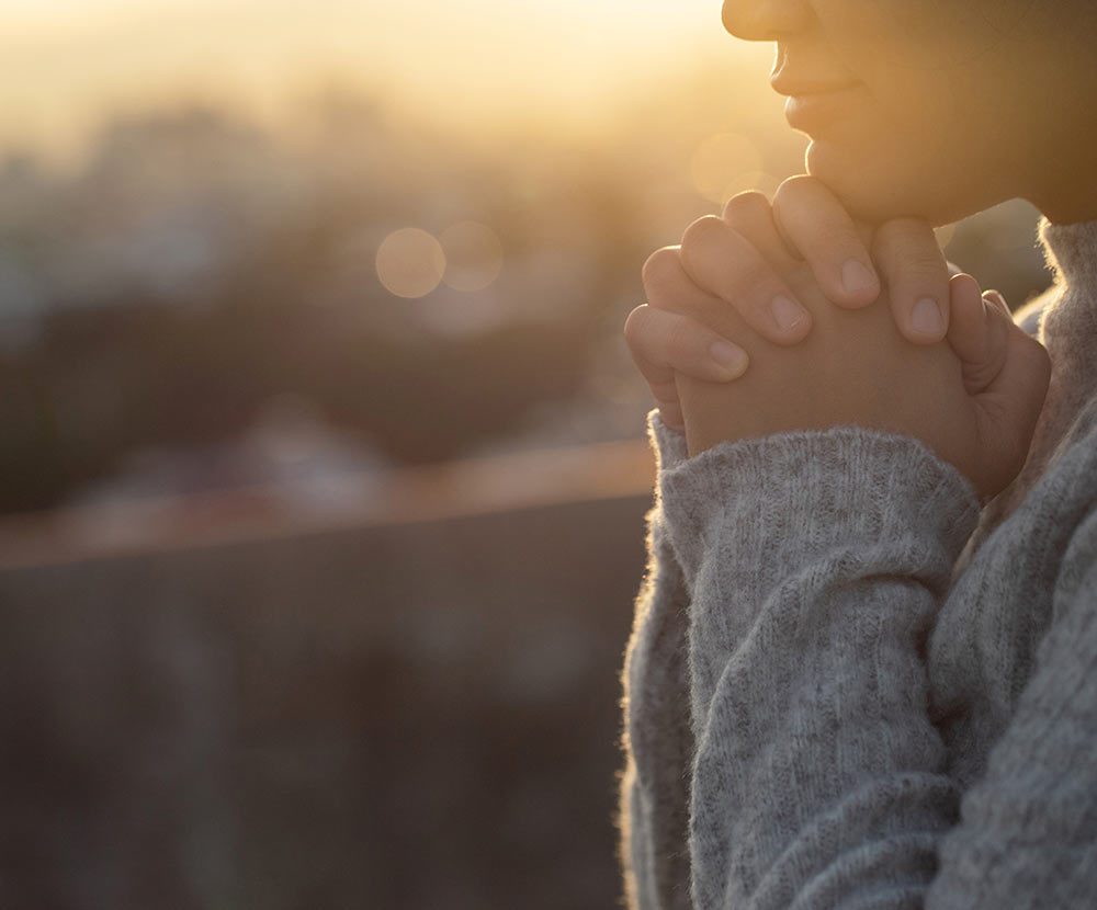 Image of a person holding their hands closed beneath their chin, as if in prayer. This image illustrates how a substance abuse counselor can help families with loved ones in addiction counseling in Birmingham, AL. 35223