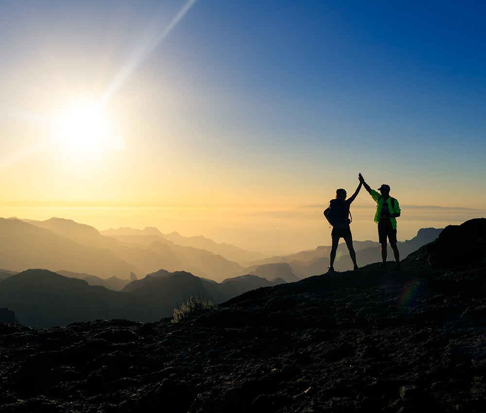 Image of two people atop a mountain. Adam, an online therapist in Alabama, approaches each individual client and couple with compassion and concern.