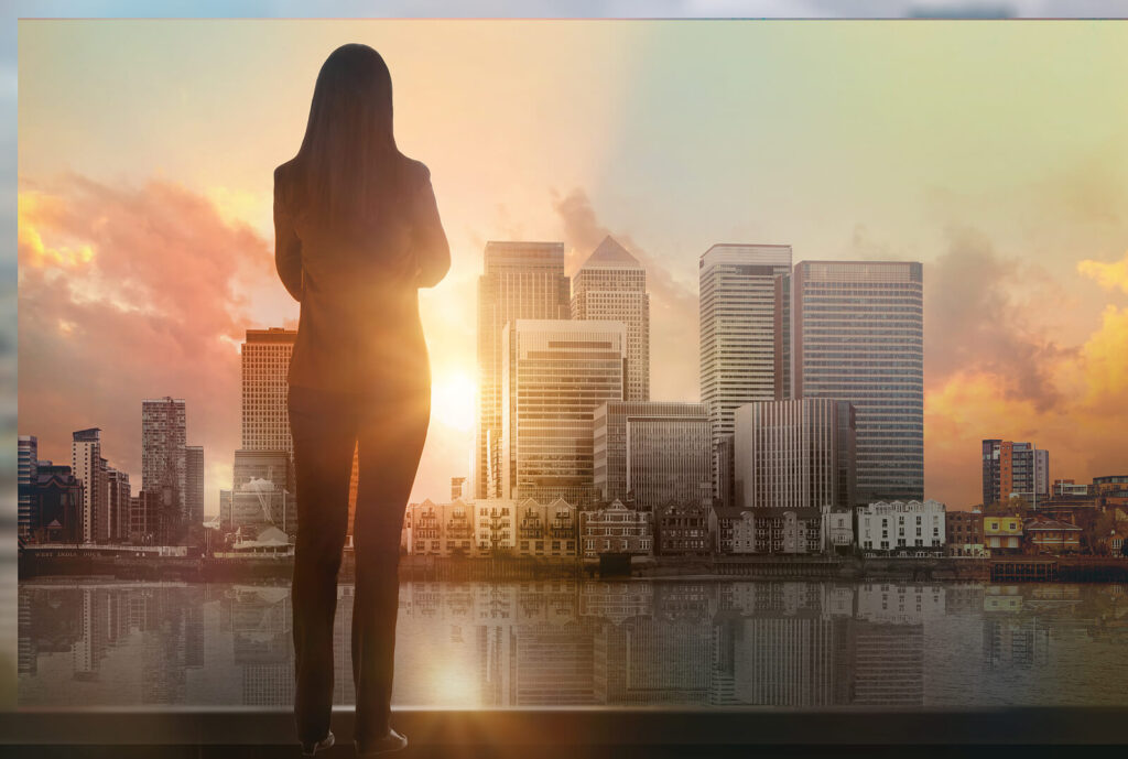 Successful business woman overlooking the city. Learn the skills to overcome bias and blind spots and reach your full potential with Executive Coaching in Alabama. 