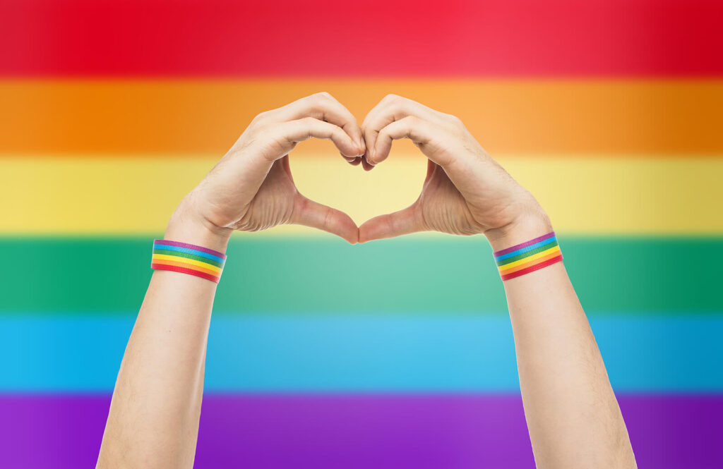 Photo of someone making a heart sign with their hands in front of a Pride flag. Feeling unmotivated and unwelcome? With depression counseling in Birmingham, AL you can speak in a safe space to become a happy and mentally healthy person. 