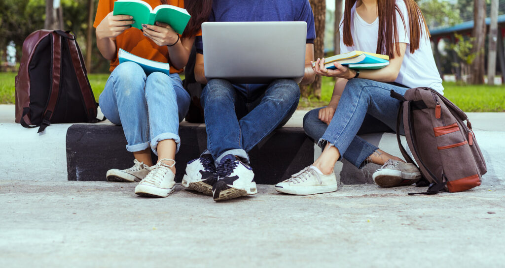 Group of college students doing homework together outside supporting each other. Social anxiety, depression, and self-esteem issues are common amongst college students. If you are battling these things, therapy for college students in Alabama can help. Learn more here.