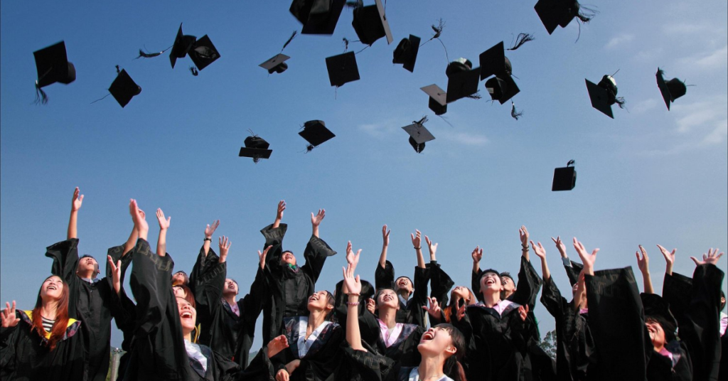 Group of college students celebrating their graduation by throwing their caps in the air. College graduation is a time of many changes, Counseling for College Students in Alabama can help navigate those new experiences.