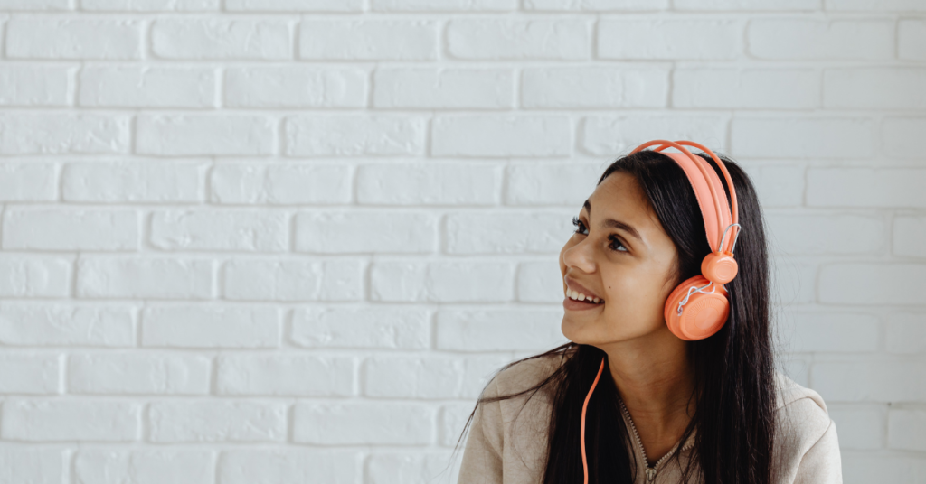 Girl with headphones smiling/ therapy for teens Empower Counseling Birmingham