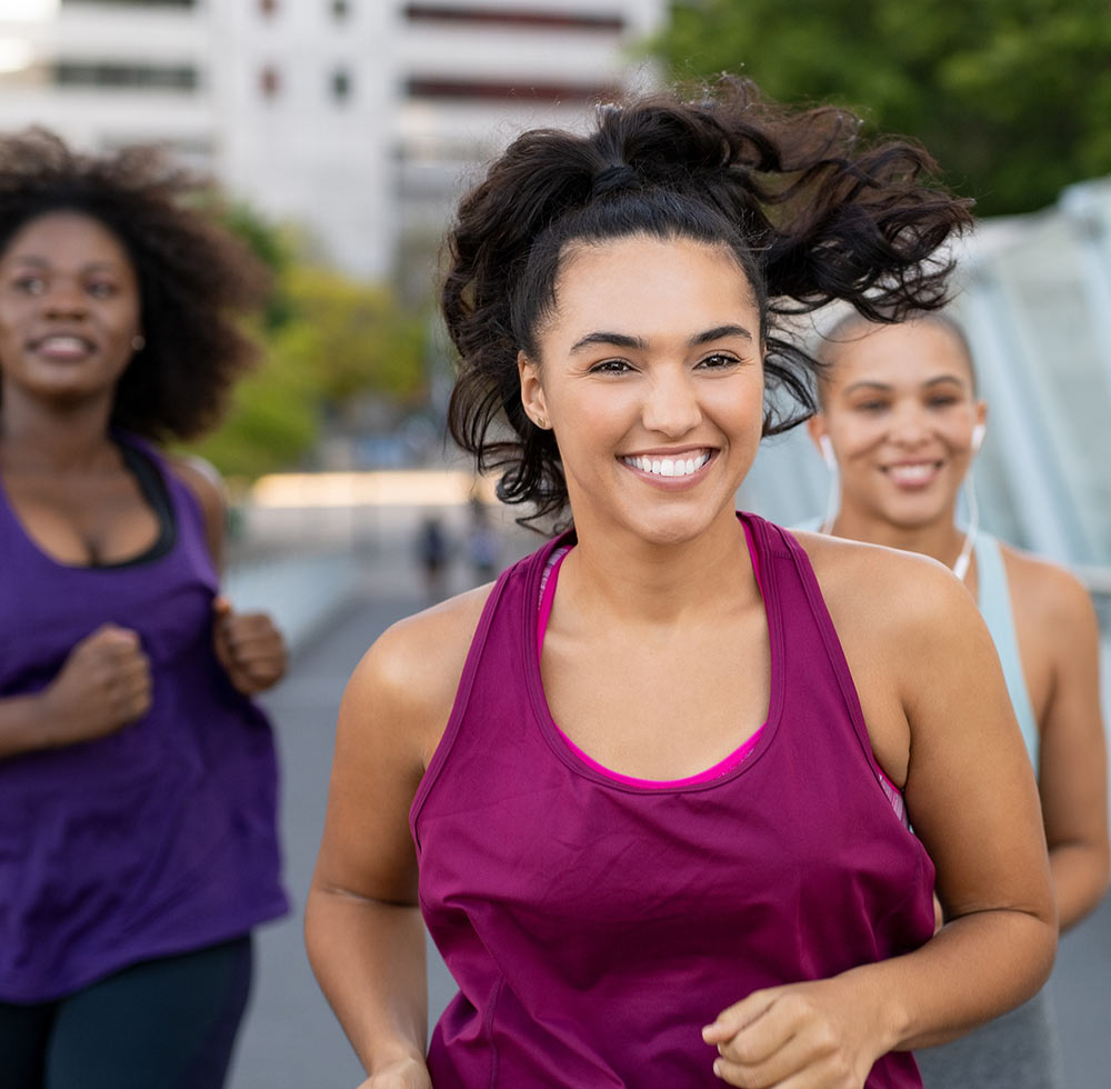 A woman runs while smiling. She is feeling much better after starting life transitions counseling in Birmingham, AL 35532 with Empower Counseling.