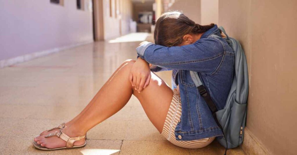 a teen upset sitting on floor/ fear of failure/ empower counseling/ Birmingham Alabama