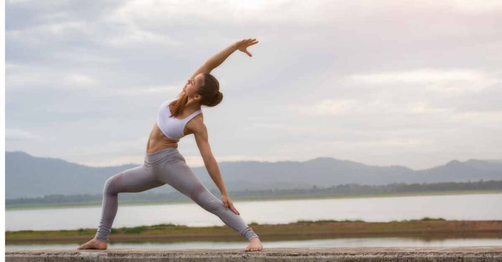 a woman doing yoga outside becoming the best version of herself in the new year