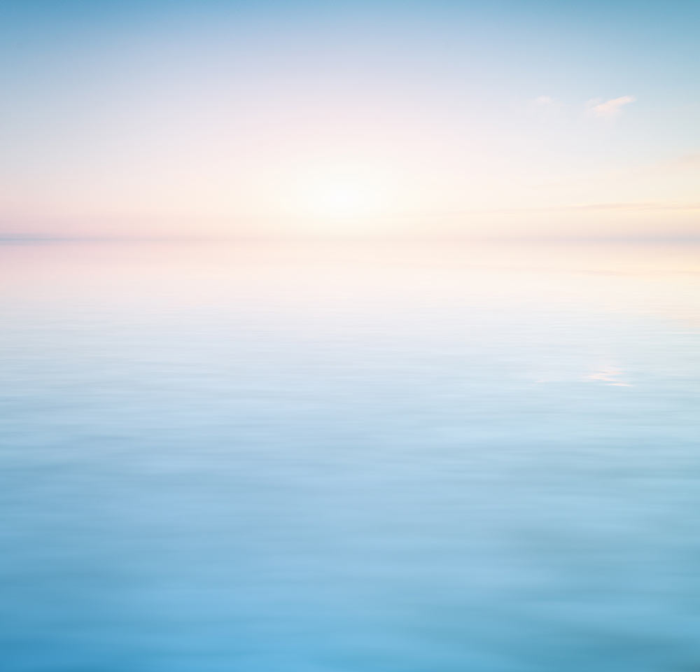 Image of calm blue water with a pink sky. In EMDR therapy in Birmingham, AL you can begin finding effective treatment for trauma.