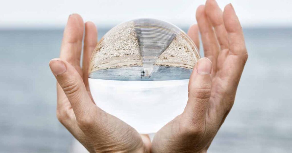 someone holding a crystal ball trying to predict 