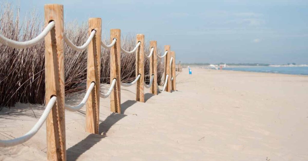 A fence on a beach signifying boundaries