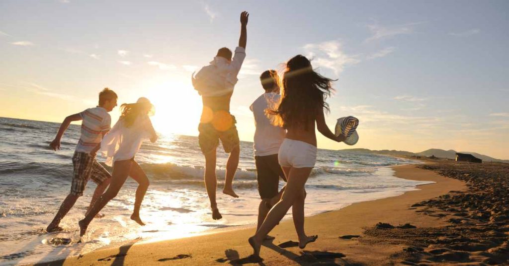 people walking and relaxing on beach