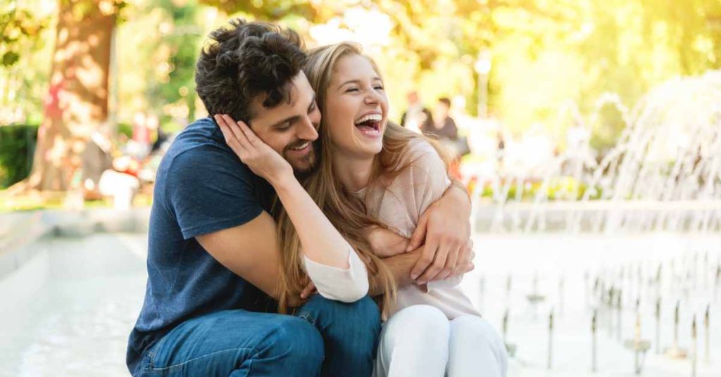 a happy couple in front of a fountain/ premarital counseling near me/ Birmingham / 35223