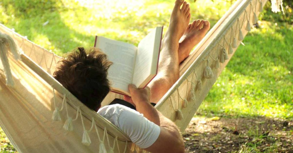 man in hammock practicing rest and recovery/helpful mental health practices/ Empower Counseling / 35223