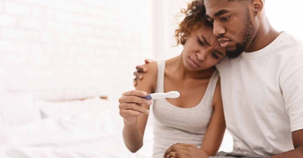 a couple looking at negative pregnancy test/ emotional impact of pregnancy/ Counseling Birmingham/ Empower Counseling/ 35223