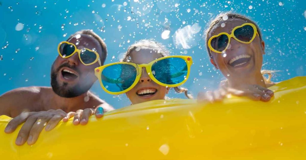 mom dad and daughter on float smiling