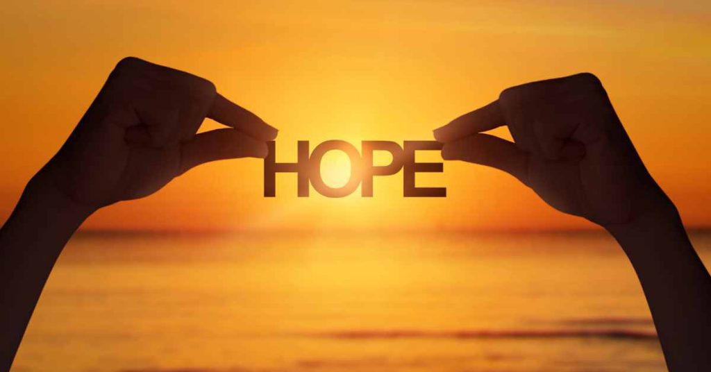 A woman holding the word "hope"