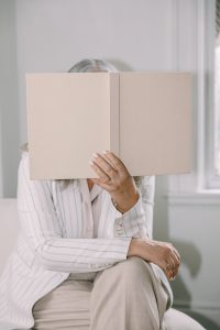 woman behind book
